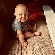Orion is registered to the contest to win money with this photo: baby, child, smiling, sitting, couch, indoors, sunlight, warm_light, face, hand, foot, clothing, texture, fabric, comfort, cute, portrait, happy, infant, cozy