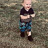 black_shoes, boots, child, daylight, face, grass, greenery, happy, lawn, outdoor, park, patterned_clothing, person, portrait, shorts, smiling, standing, striped_shirt, toddler, toy