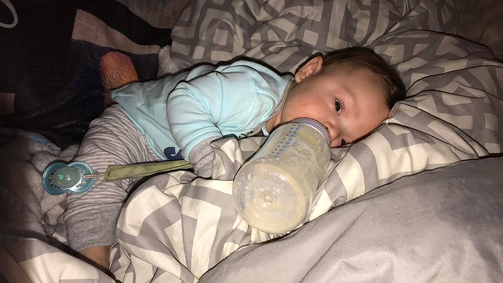 Ricky is registered to the contest to win money with this photo: baby, baby_products, baby_toddler_clothing, bedding, bedtime, child, comfort, drinkware, linens, nap, person, room, sitting, sleep, textile, toddler