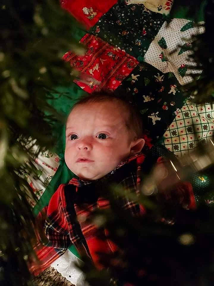 Luka is registered to the contest to win money with this photo: baby, baby_toddler_clothing, carmine, christmas, christmas_decoration, christmas_eve, christmas_ornament, christmas_tree, conifer, fir, holiday, holiday_ornament, ornament, pattern, person, plaid, red, tartan, toddler