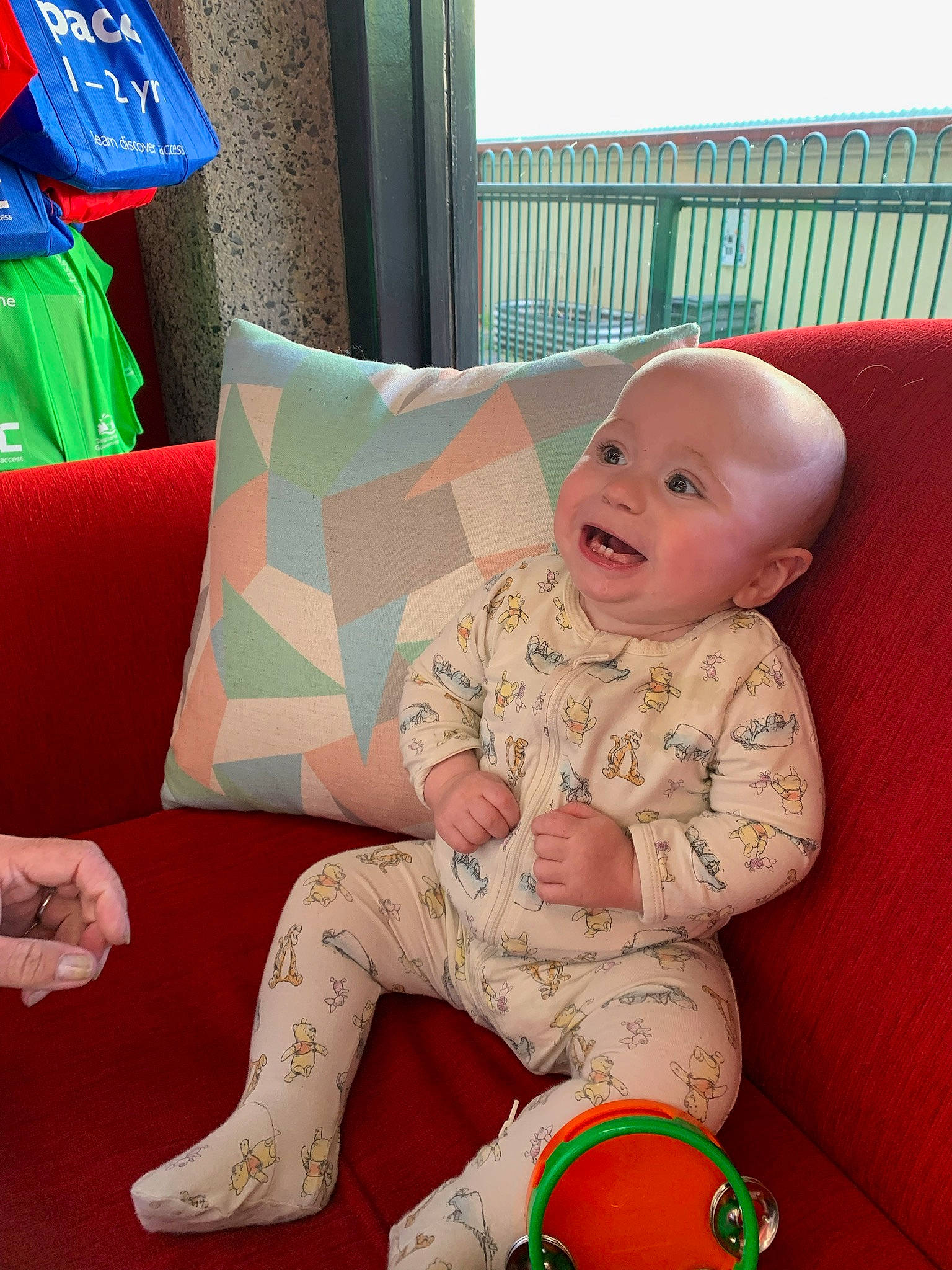 Malakai is registered to the contest to win money with this photo: baby, baby_toddler_clothing, child, comfort, couch, flooring, fun, happy, human_leg, lap, linens, living_room, mammal, person, product, room, sitting, smile, sock, thigh