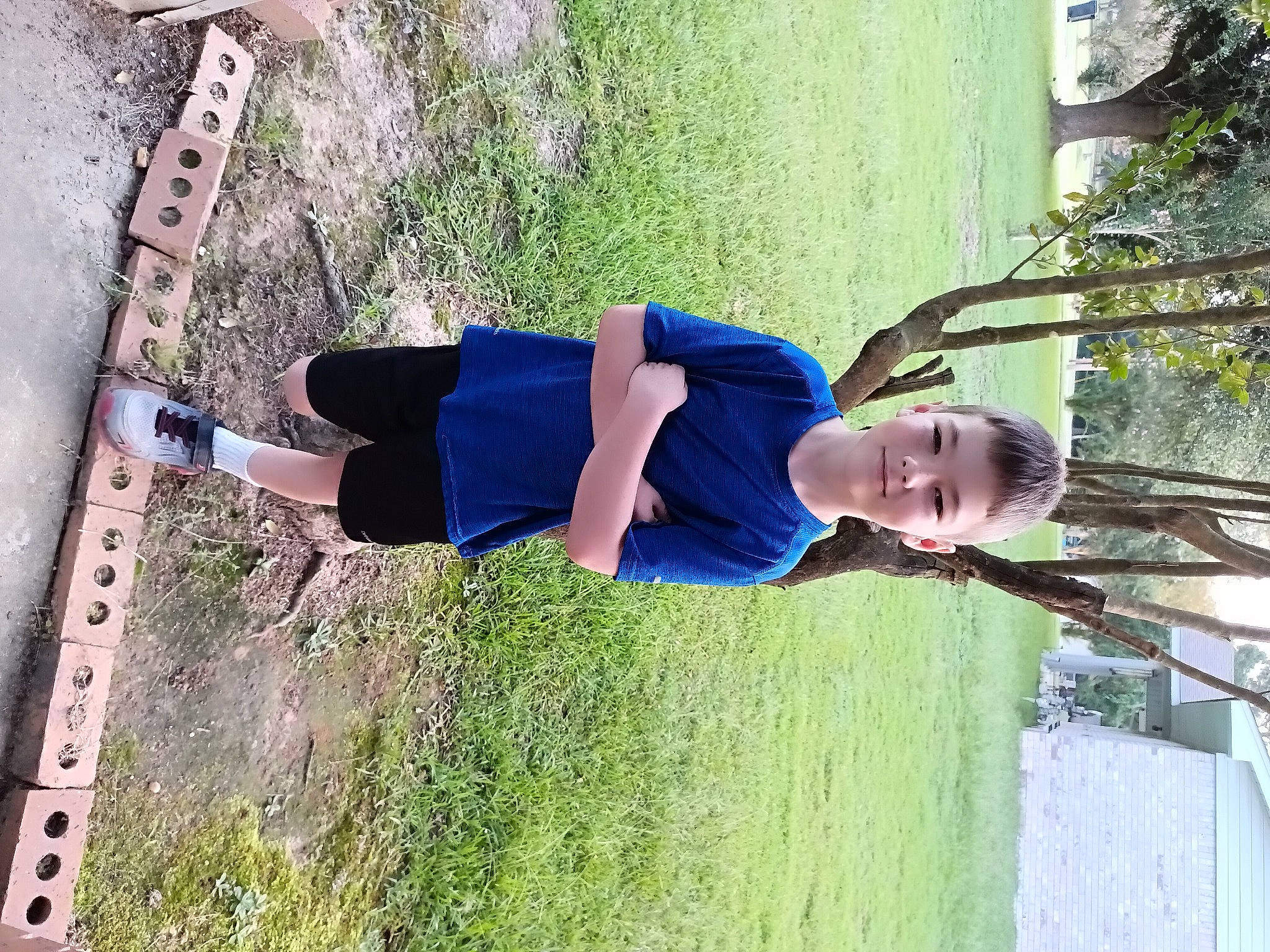 Dalton is registered to the contest to win money with this photo: elbow, electric_blue, fun, grass, happy, hat, human_leg, joy, knee, leisure, people_in_nature, person, plant, shadow, shorts, smile, t_shirt, thigh, toddler, tree