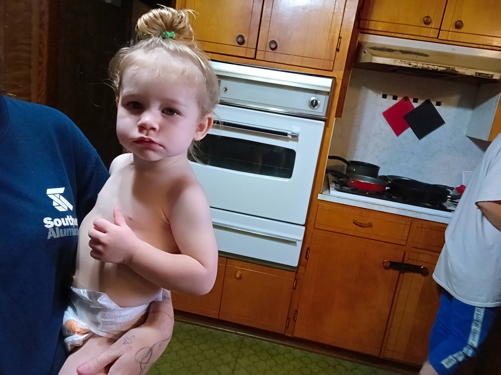 Athena is registered to the contest to win money with this photo: abdomen, baby, cabinetry, chest, cupboard, drawer, elbow, flooring, gesture, happy, home_appliance, kitchen, kitchen_appliance, major_appliance, person, refrigerator, room, t_shirt, thigh, toddler