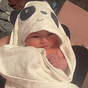 Evelyn is registered to the contest to win money with this photo: baby, towel, panda, face, child, wrapped, cute, indoors, blanket, soft, person, skin, hand, newborn, infant, expression, clothing, warm, cozy, portrait