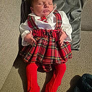 Reneya-Mae is registered to the contest to win money with this photo: baby, infant, sleeping, red_tights, plaid_skirt, white_blouse, couch, pillow, indoors, cozy, child, soft_lighting, clothing, resting, hands, face, cute, young_child, fabric, home