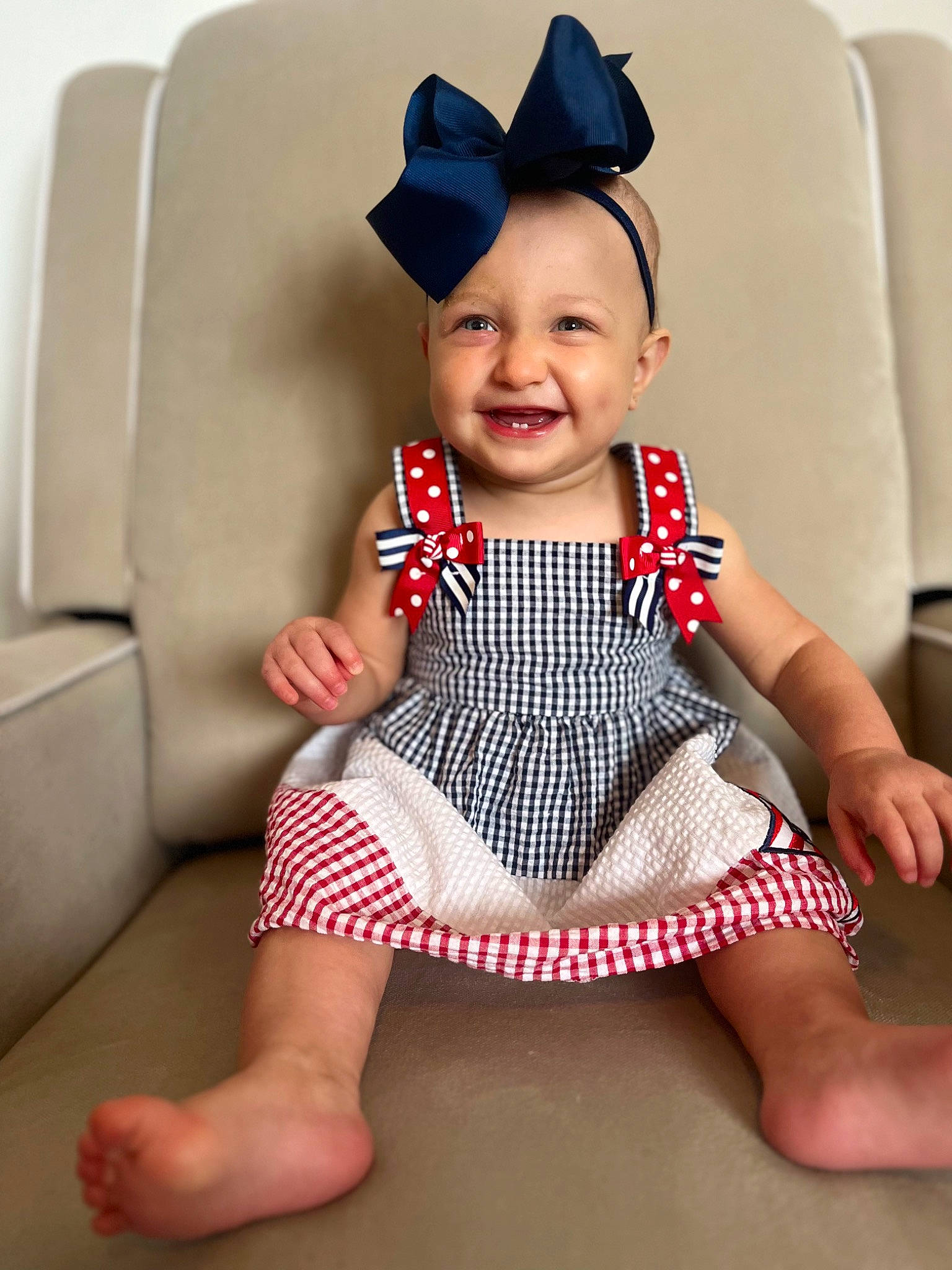 Kinsley is registered to the contest to win money with this photo: arm, baby, baby_toddler_clothing, cap, chin, collar, costume_hat, happy, hat, human_body, human_leg, joy, lip, neck, pattern, person, sitting, skin, sleeve, smile