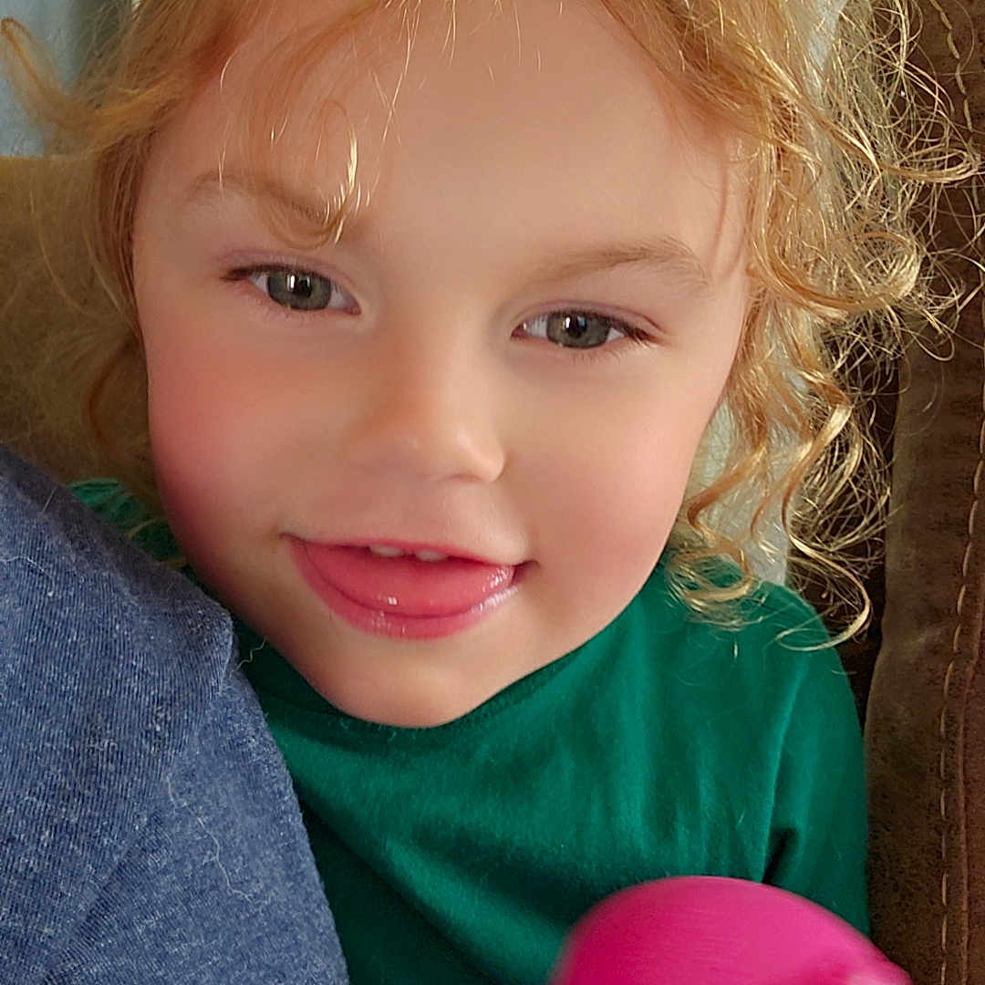 Hailey is registered to the contest to win money with this photo: baby, bodypart, candy, clothing, cosmetics, face, finger, food, hand, head, jeans, lipstick, mouth, pants, person, photography, portrait, sphere, sweets, toy