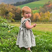 Rose joined the competition — help win amazing prizes! child, toddler, girl, outdoor, field, grass, mountains, landscape, autumn, nature, dress, frilly_dress, blonde_hair, portrait, standing, serious_expression, scenery, rural, farmland, daylight