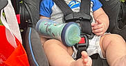 Taylen is registered to the contest to win money with this photo: baby, child, car_seat, sunglasses, star_shaped, blue, bottle, outdoor, grass, grass_field, infant, clothing, foot, seatbelt, person, cute, summer, sunny, expression, closeup
