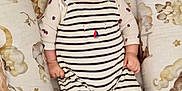 Noham a rejoint le concours — aidez-le/la à gagner de superbes lots ! baby, smiling, hat, striped_clothing, shoes, baby_nest, cozy, infant, happy, person, cute, child, indoors, fabric, pattern, soft_toys, comfortable, portrait, newborn, clothing