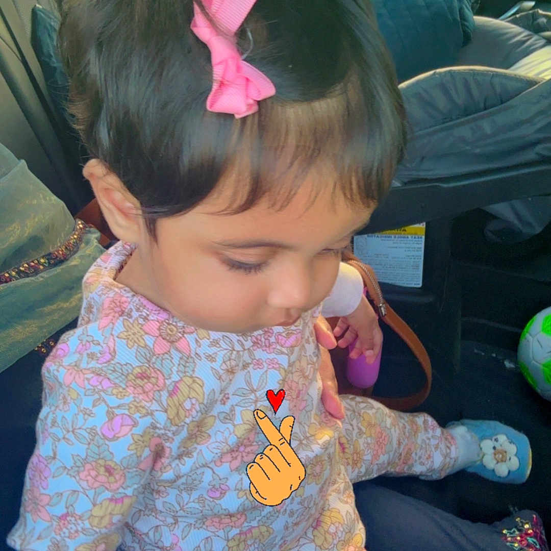 Gul joined the competition — help win amazing prizes! toddler, child, car_interior, pink_bow, floral_outfit, sitting, cute, indoors, seat, child_seat, toy, footwear, window, greenery_outside, portrait, young_child, casual_clothing, cartoon_overlay, heart, hair_accessory