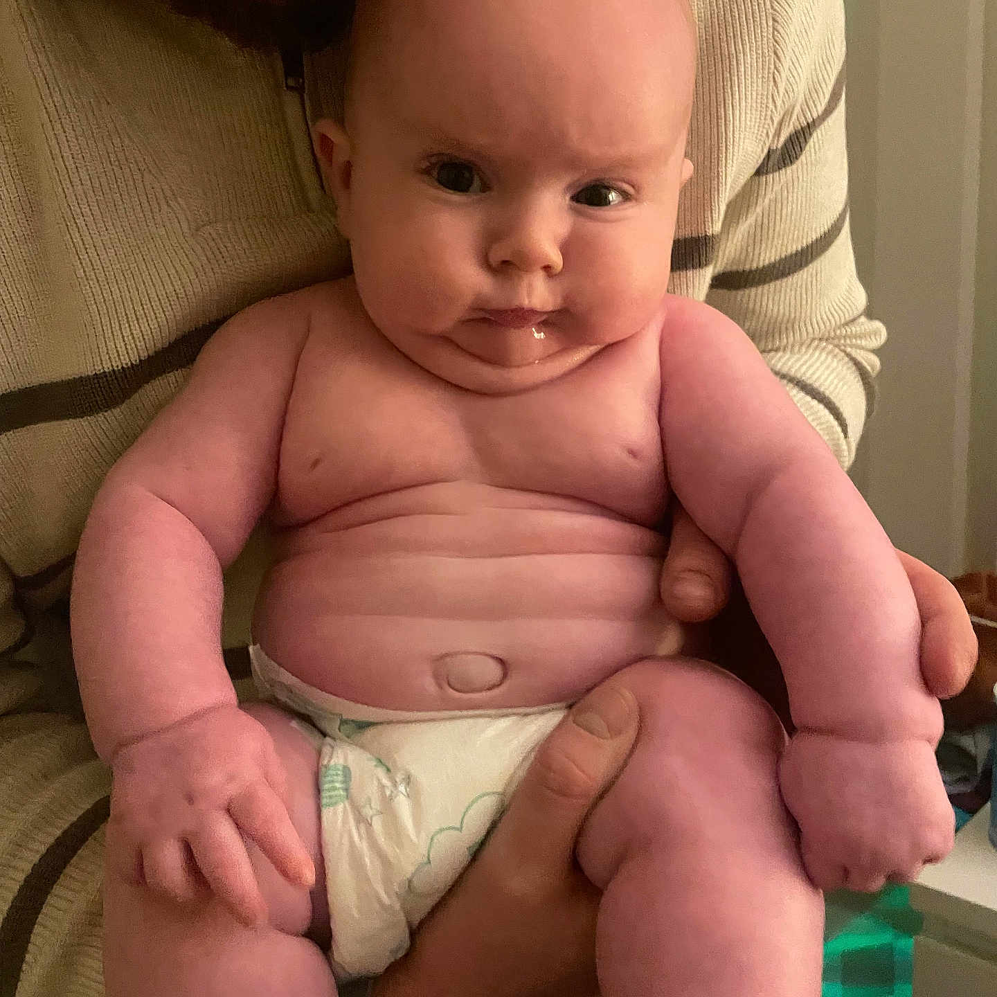 Noah is registered to the contest to win money with this photo: baby, bodypart, chair, diaper, face, finger, furniture, hand, head, newborn, person, photography, portrait, sitting, toy