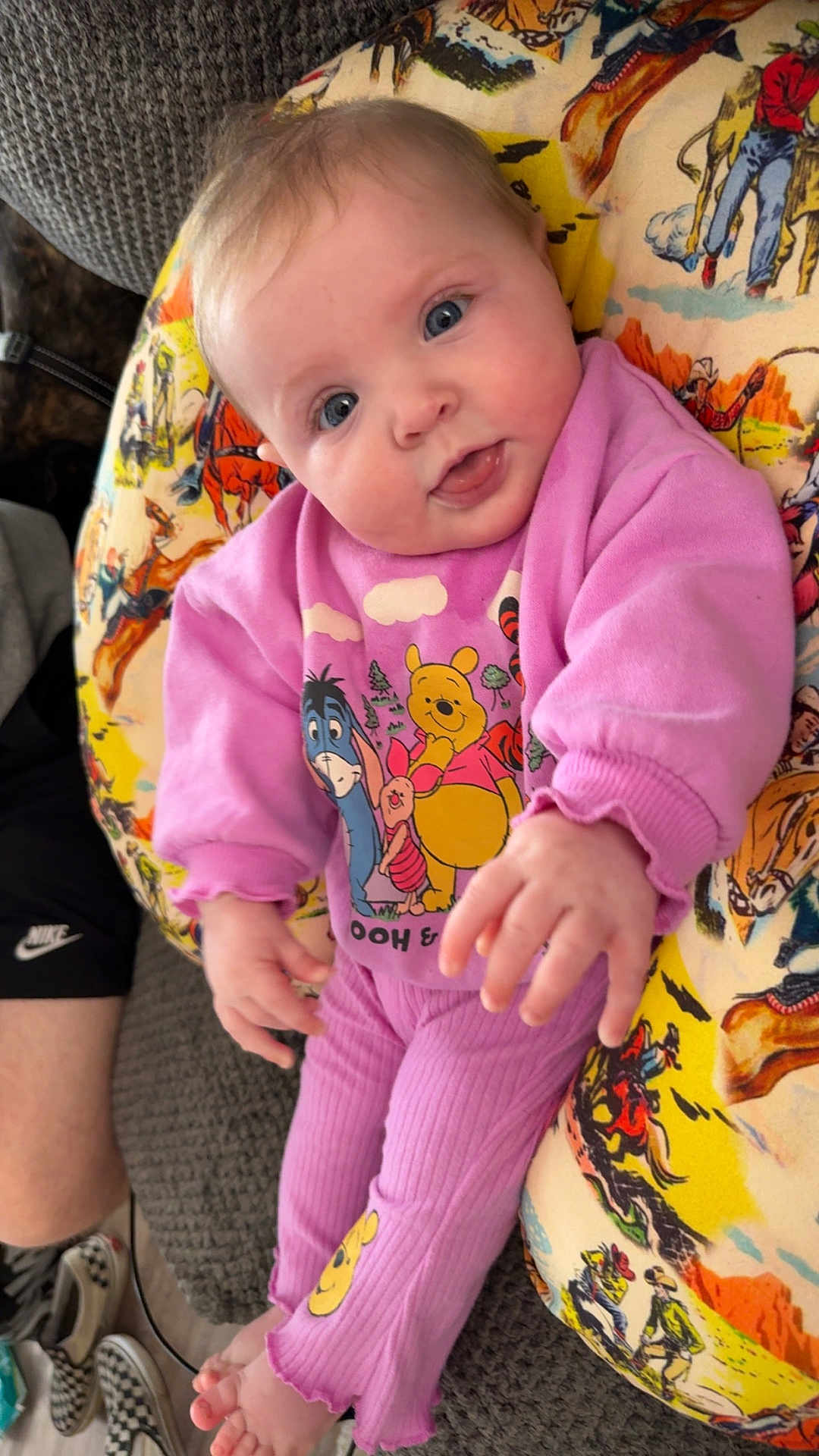 Wrenley joined the competition — help win amazing prizes! baby, infant, child, pink_clothing, winnie_the_pooh, blue_eyes, tongue_out, smile, close_up, portrait, hand, feet, patterned_blanket, pillow, sofa, couch, casual, home_interior, cute, outfit