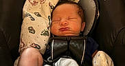 Jax is registered to the contest to win money with this photo: baby, blanket, car_seat, child, closeup, clothing, comfort, cute, face, head, indoors, infant, mitten, newborn, peaceful, resting, safety_harness, sleeping, sock, soft_lighting