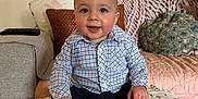 Harrison joined the competition — help win amazing prizes! baby, child, smile, shirt, pants, shoes, blanket, couch, pillow, indoor, happy, sitting, face, person, head, clothing, footwear, home, cute, young