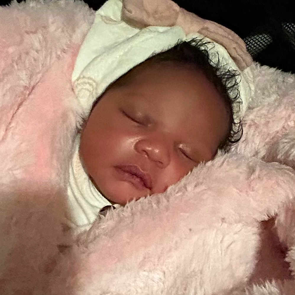 Aine is registered to the contest to win money with this photo: baby, blanket, bonnet, cap, clothing, coat, face, hat, head, homedecor, hood, jacket, newborn, person, photography, portrait, quilt, sleeping, towel