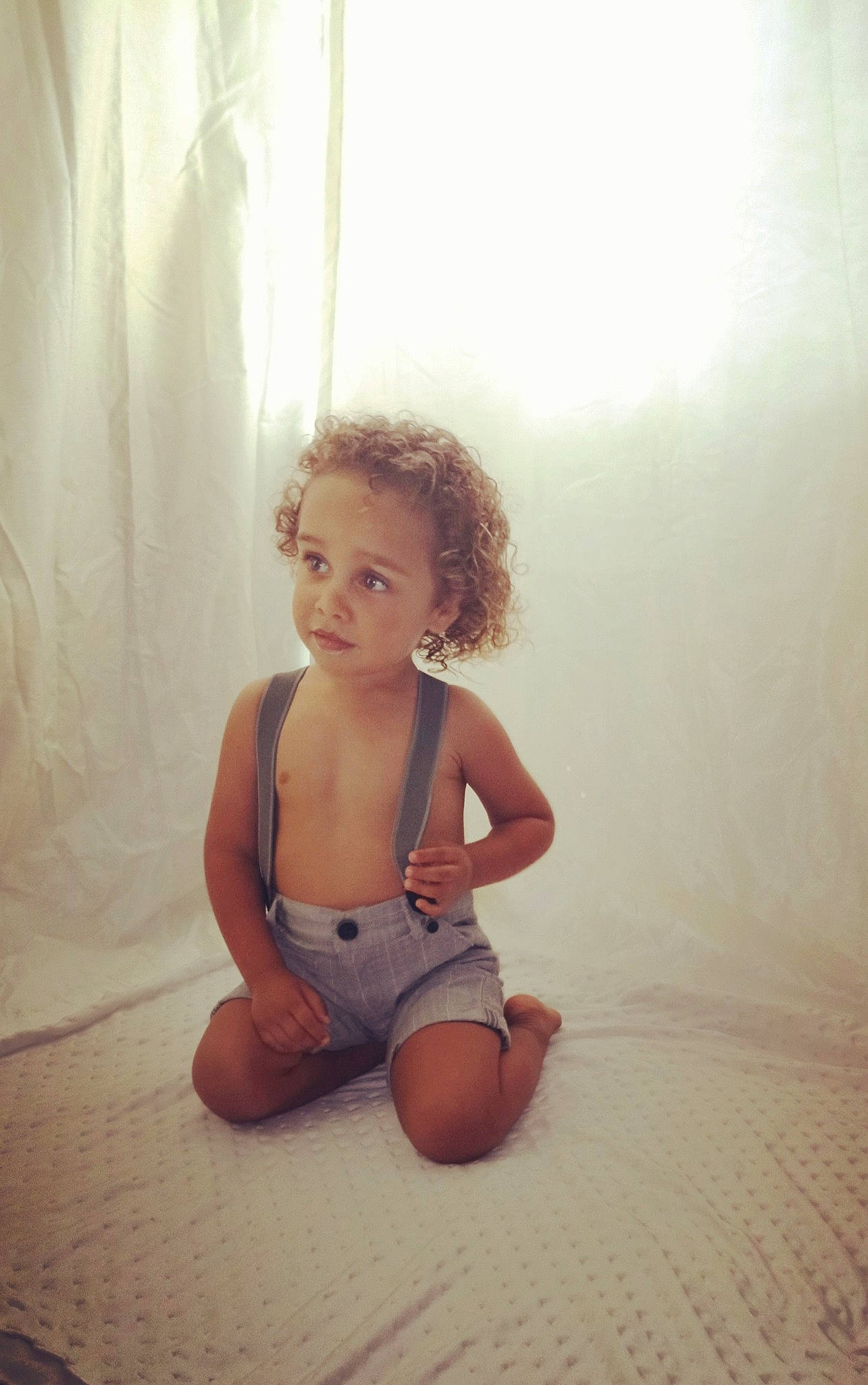 Antonio is registered to the contest to win money with this photo: child, floor, flooring, joint, leg, person, photography, shoulder, sitting, skin, smile, standing, toddler, wood