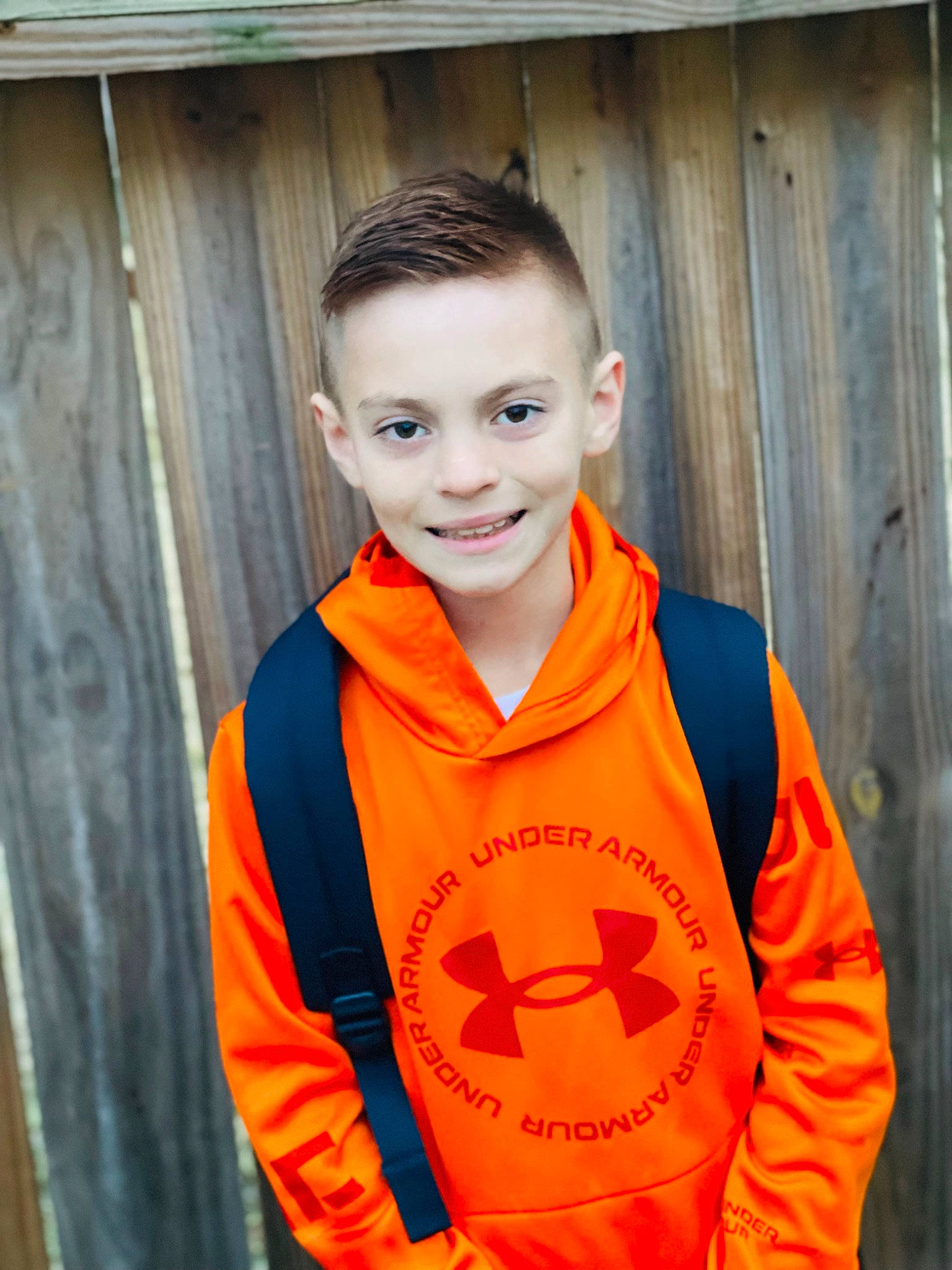 Karsin is registered to the contest to win money with this photo: caesar_cut, child, collar, crew_cut, electric_blue, fun, happy, hoodie, jersey, joy, orange, person, personal_protective_equipment, portrait_photography, sleeve, smile, sportswear, t_shirt, uniform, vest