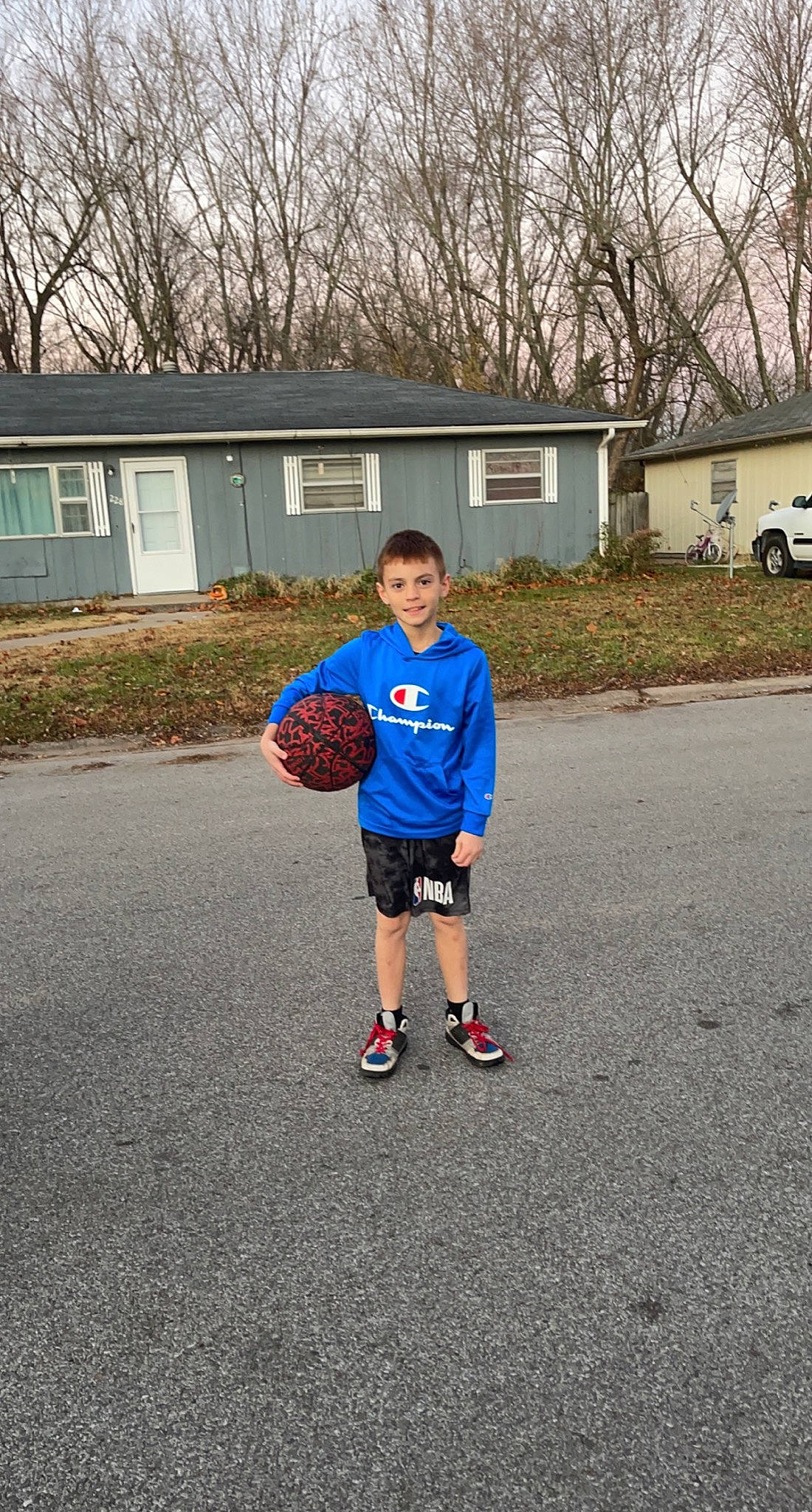 Karsin is registered to the contest to win money with this photo: arm, asphalt, ball, footwear, grass, house, joy, knee, leisure, person, plant, player, recreation, rolling, shorts, sky, sports, sports_equipment, sportswear, t_shirt