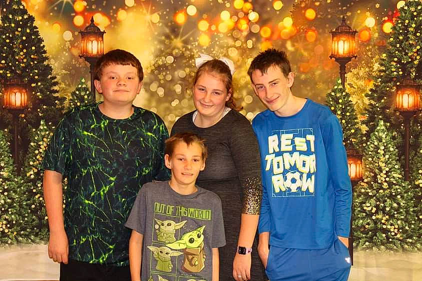 Sequoia is registered to the contest to win money with this photo: child, christmas_decoration, christmas_ornament, christmas_tree, decoration, facial_expression, family_taking_photos_together, fun, happy, joy, leisure, light, lighting, ornament, person, plant, red, smile, social_group, standing