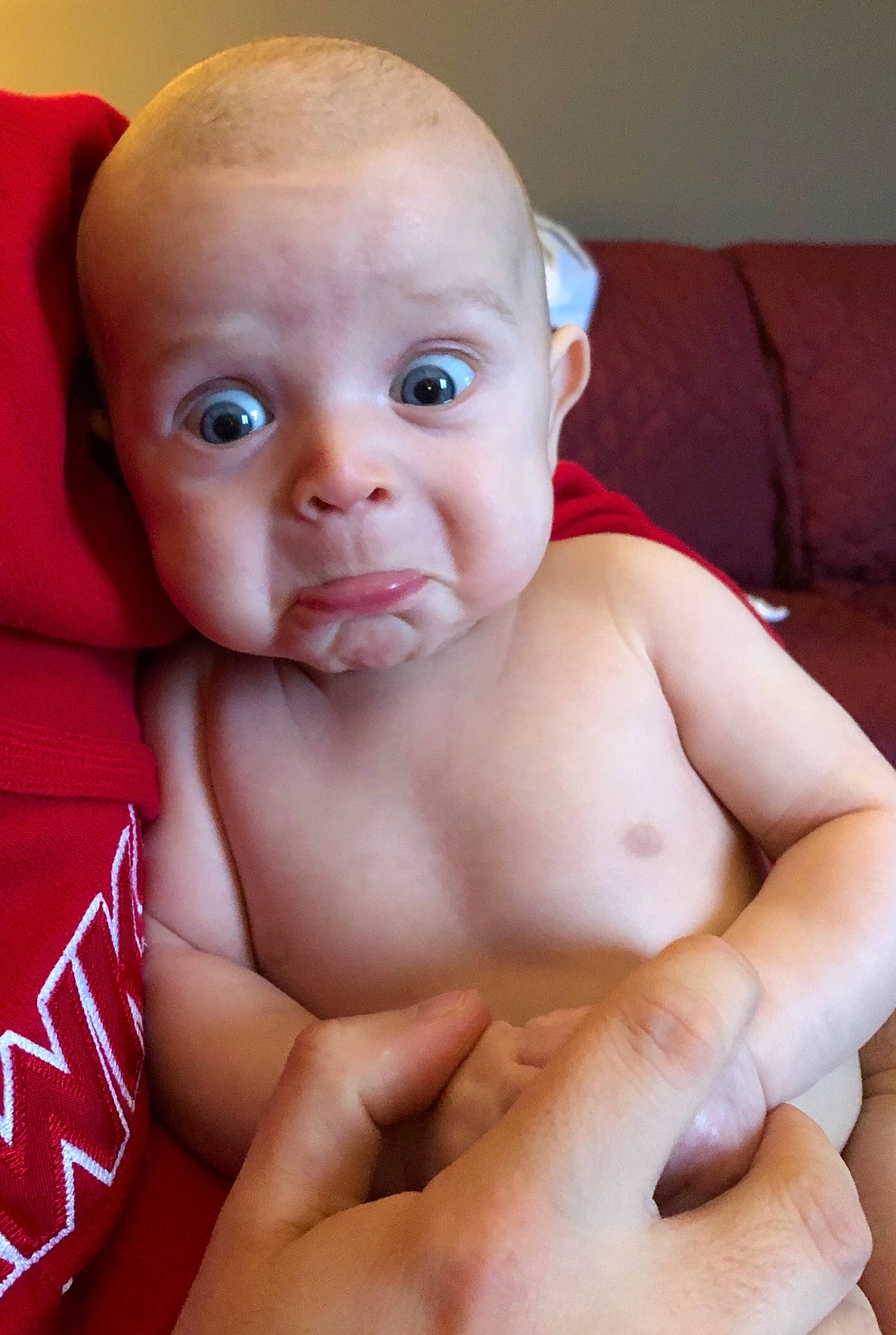 Cole is registered to the contest to win money with this photo: baby, baby_making_funny_faces, cheek, child, chin, close_up, eye, face, finger, hand, head, lip, mouth, muscle, nose, person, sitting, skin, toddler, tummy_time