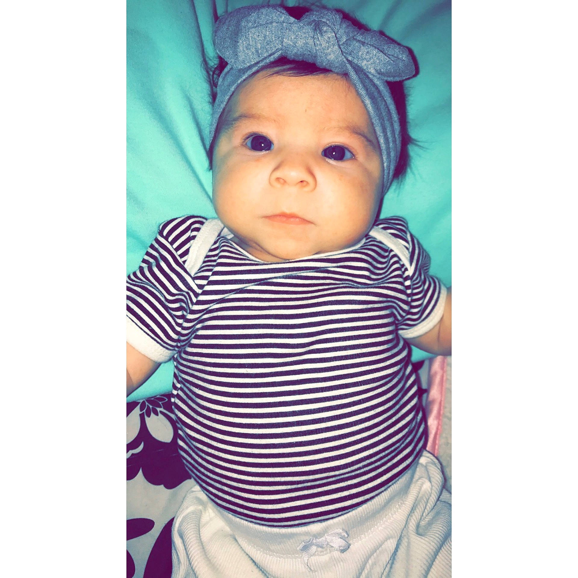 Jaylani joined the competition — help win amazing prizes! baby_products, bonnet, cap, cheek, child, hair_accessory, headgear, infant, lavender, outerwear, pattern, person, product, purple, sleeve, textile, toddler, violet