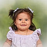 toddler, child, girl, smile, pigtails, hair_bows, purple_dress, gingham, portrait, cute, happy, young_child, earrings, necklace, studio_photo, soft_background, innocent, baby_face, closeup, outdoor_background