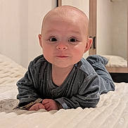 Naëlynn participe au concours pour gagner de l'argent avec cette photo : baby, infant, child, bed, bedding, blanket, blue_clothing, face, portrait, indoors, cute, lying_down, looking_at_camera, soft_light, room, pacifier, hand, head, expression, young_child