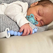 Rayan is registered to the contest to win money with this photo: baby, sleeping, pacifier, hand, face, infant, blanket, clothing, closeup, cozy, rest, newborn, soft, cute, child, bed, comfort, peaceful, indoors, skin