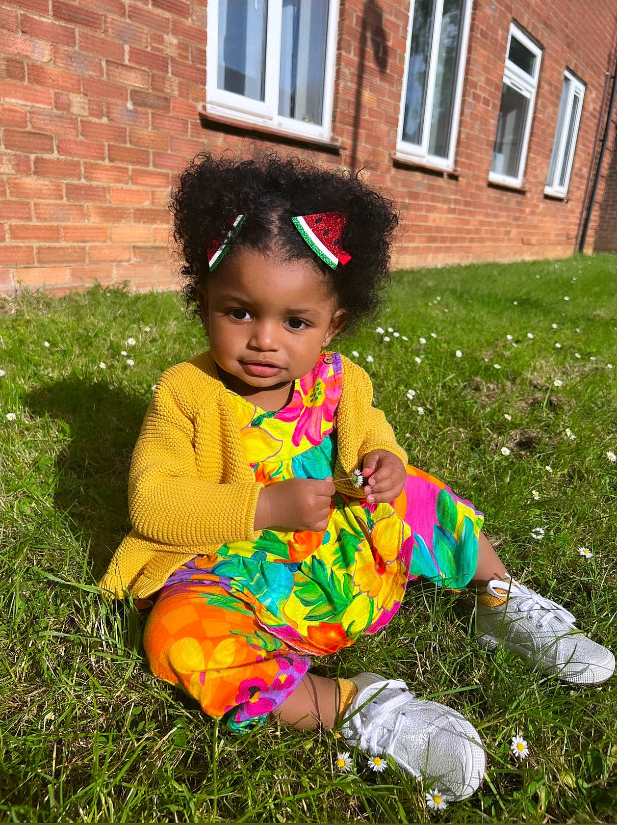 Kamila joined the competition — help win amazing prizes! baby_toddler_clothing, brick, child, footwear, grass, grass_family, grassland, happy, house, lawn, leaf, magenta, pattern, people_in_nature, person, pink, plant, sitting, toddler, tree