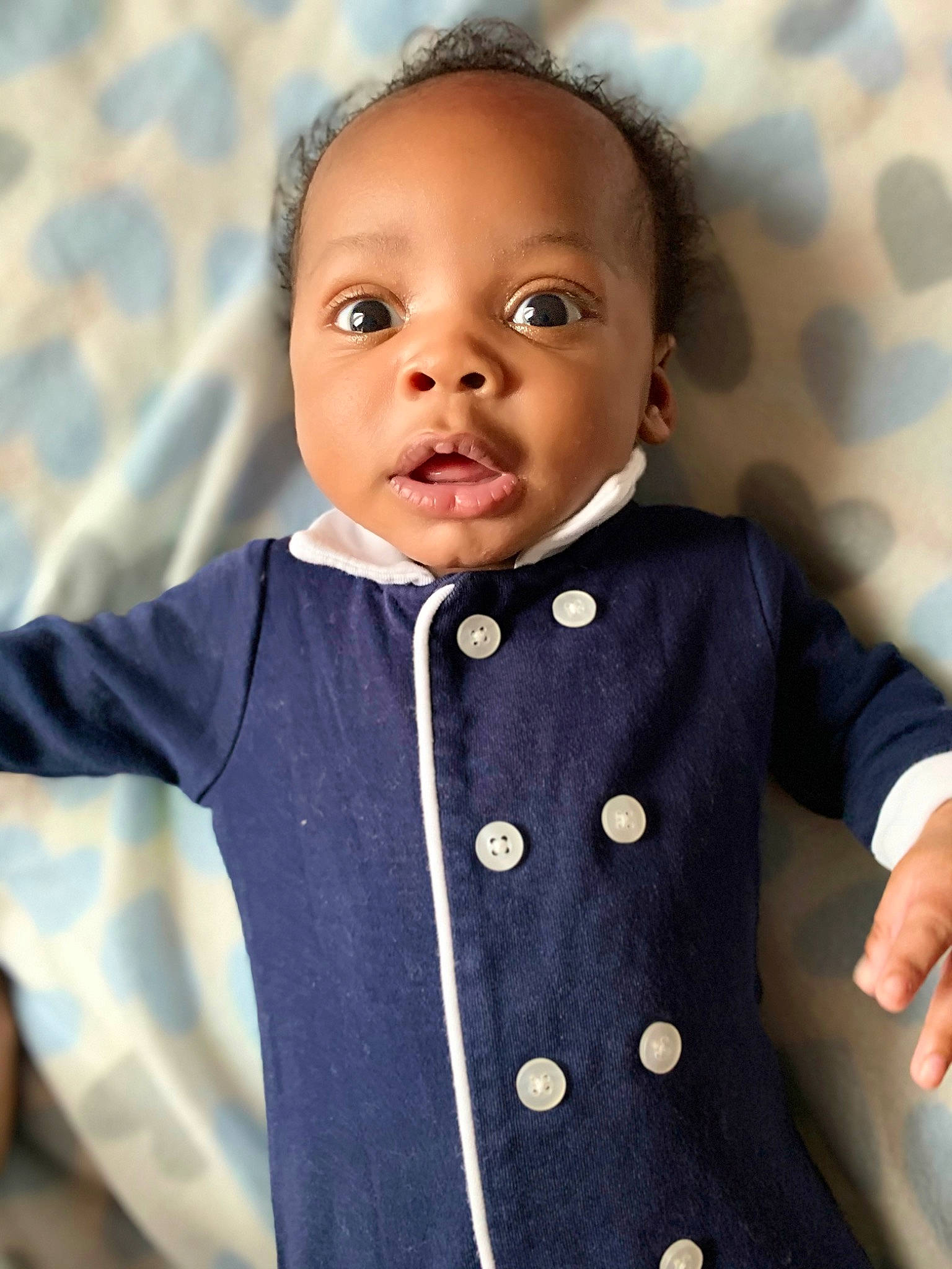 Hakeem is registered to the contest to win money with this photo: baby, bow_tie, cheek, child, formal_wear, outerwear, person, suit, tie, toddler, tuxedo