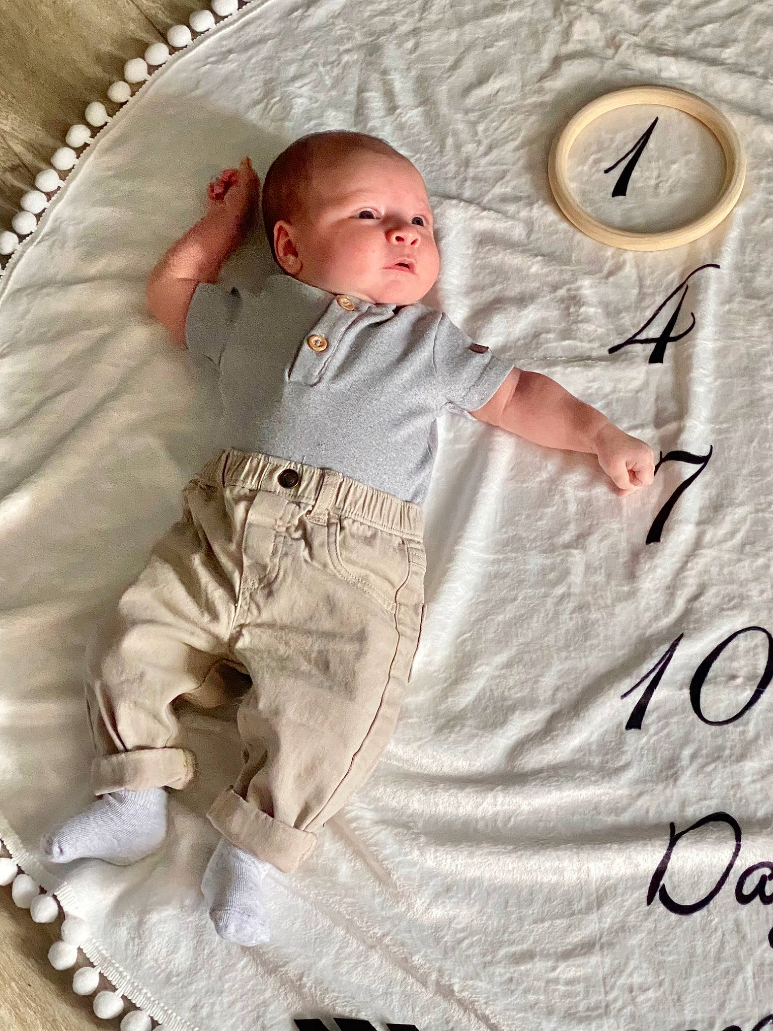 Oliver is registered to the contest to win money with this photo: baby, baby_products, baby_safety, baby_sleeping, baby_toddler_clothing, bedding, child, circle, clock, comfort, gesture, happy, infant_bed, linens, pattern, person, sitting, sleeve, t_shirt, textile