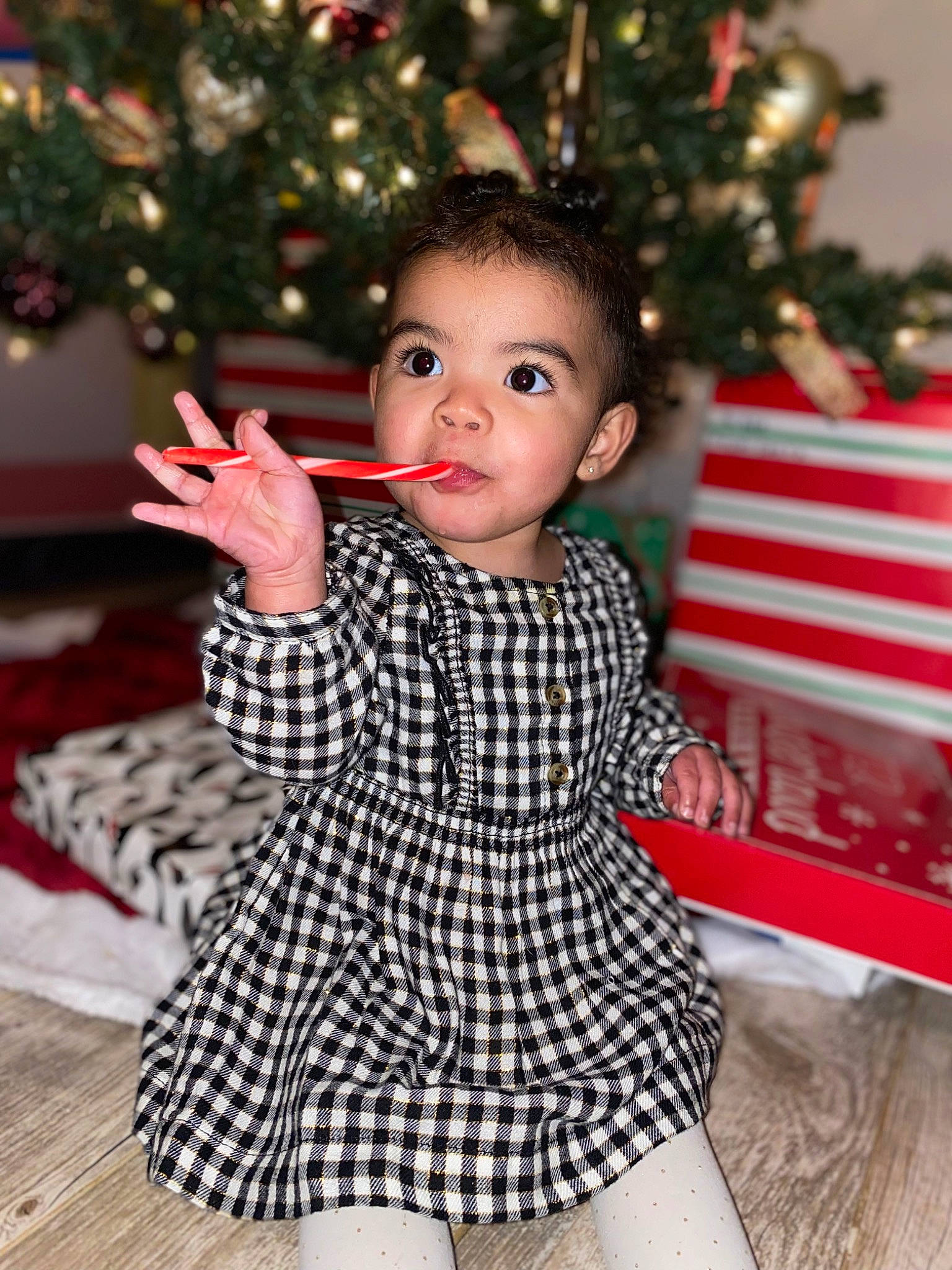 Asa is registered to the contest to win money with this photo: baby_toddler_clothing, beauty, christmas_decoration, christmas_ornament, christmas_tree, event, eye, face, finger, gesture, hair, happy, head, holiday, person, photograph, skin, sleeve, standing, toddler