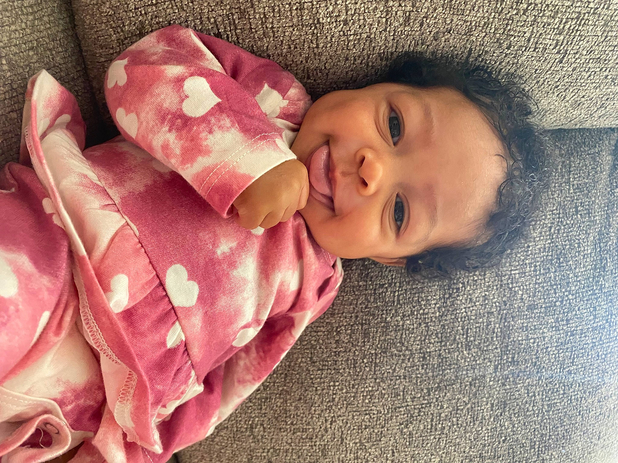 Ava is registered to the contest to win money with this photo: baby, baby_toddler_clothing, cheek, comfort, eyebrow, hair, happy, iris, linens, lip, magenta, nose, pattern, person, rose, skin, sleeve, smile, toddler, window