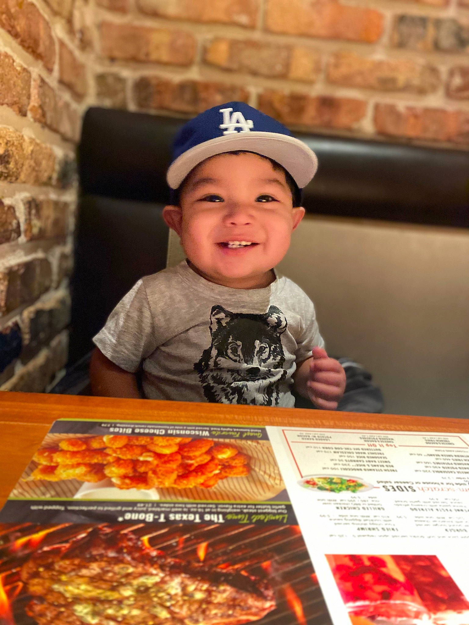 Joseph is registered to the contest to win money with this photo: baseball_cap, brick, brickwork, cap, child, comfort_food, cuisine, dish, event, finger_food, happy, headwear, ingredient, joy, junk_food, orange, person, recreation, smile, t_shirt