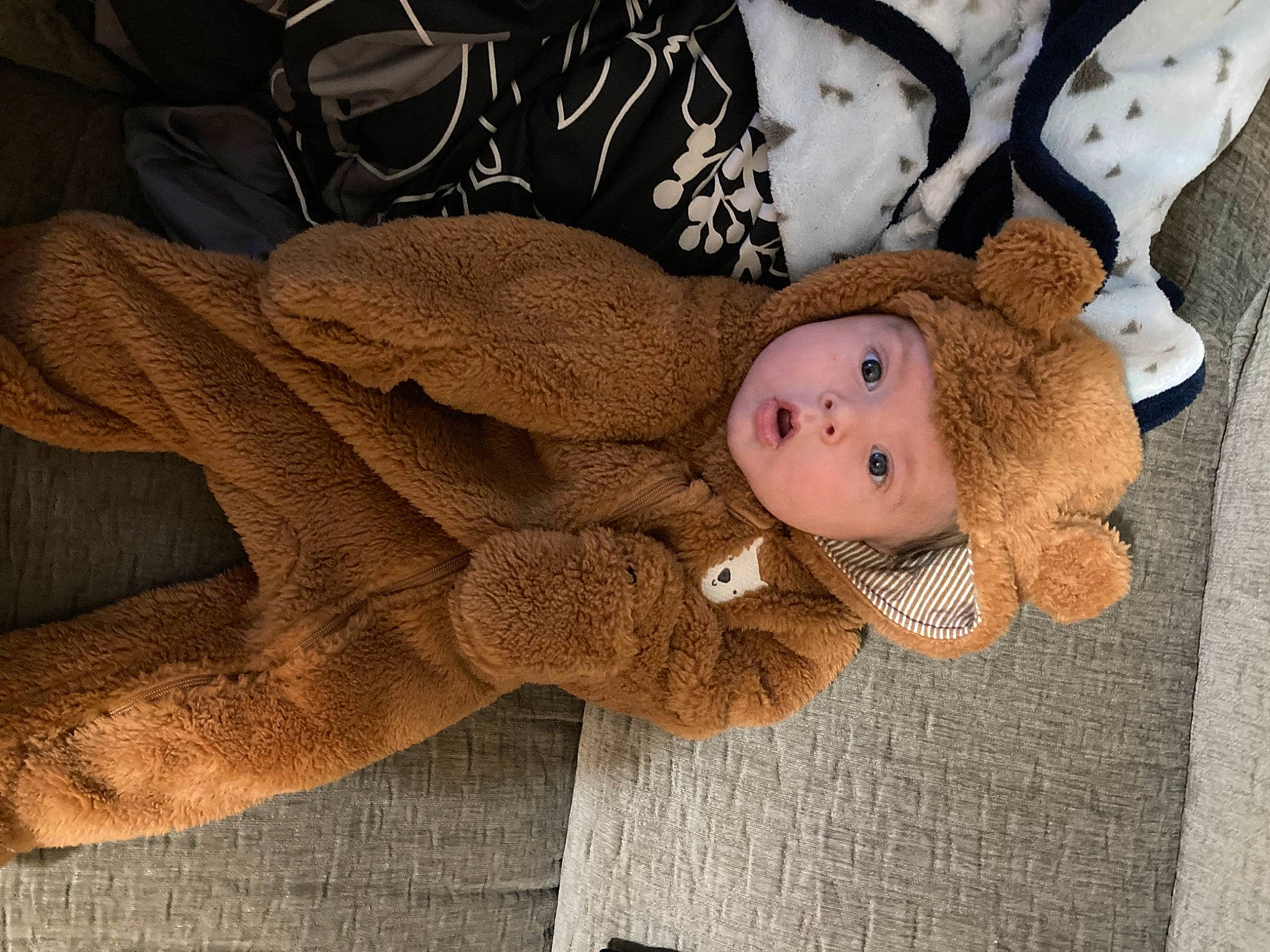 Kaison is registered to the contest to win money with this photo: arm, baby, baby_toddler_clothing, child, comfort, eye, fawn, fur, headwear, knit_cap, linens, pattern, person, plush, skin, sleeve, stuffed_toy, surprise, thigh, toddler