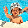 blue, bucket_hat, child, fun, happy, hat, holiday, outdoor, person, playful, pool, shadow, skin, smiling, summer, sunlight, swimming, toddler, water, waving