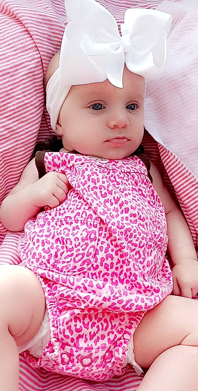 Londyn is registered to the contest to win money with this photo: baby, baby_toddler_clothing, cheek, child, collar, comfort, eyelash, finger, happy, headwear, lip, magenta, neck, organ, pattern, person, pink, skin, sleeve, textile
