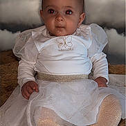 Alba participe au concours pour gagner de l'argent avec cette photo : baby, child, infant, white_dress, sparkly, tights, sitting, portrait, face, red_eye, cute, hands, background, clouds, soft_lighting, expression, floor, clothing, baby_fashion, indoor