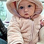 baby, child, hoodie, fur, cute, portrait, face, big_eyes, hand, soft_texture, warm_clothing, indoor, person, closeup, adorable, infant, pink, cozy, looking_at_camera, young