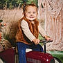 brown_vest, child, cushion, cute, decor, greenery, happy, indoor, jeans, long_sleeve_shirt, macrame, person, pigtails, playful, portrait, smiling, toddler, toy_car, vintage_toy, white_socks