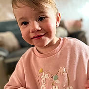 Tally participe au concours pour gagner de l'argent avec cette photo : background, casual_clothing, child, cozy, cute, expression, face, furniture, hair, happy, indoors, person, pink_clothing, portrait, skin, smiling, sweater, toddler, warmth, young_child