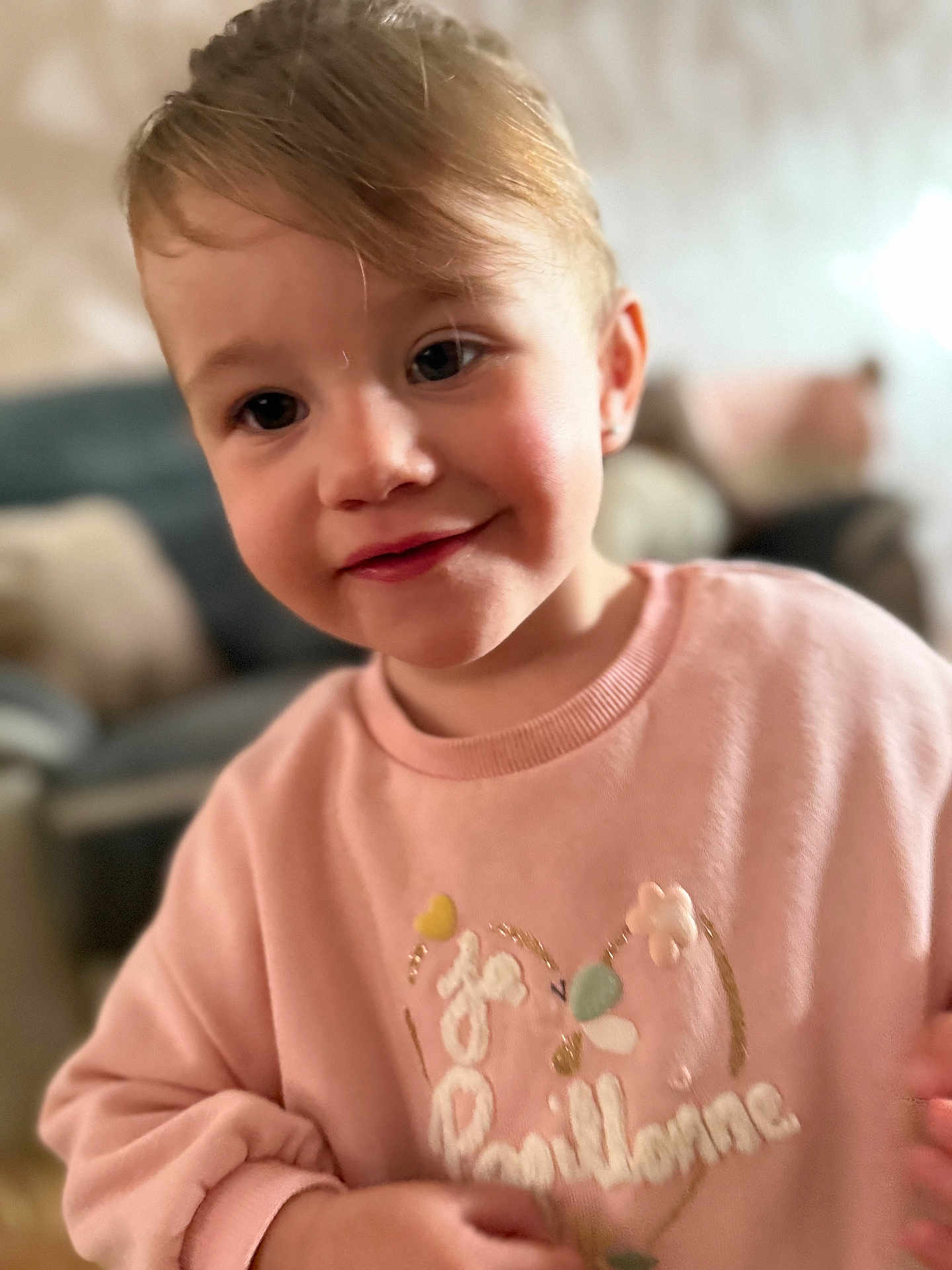 Tally participe au concours pour gagner de l'argent avec cette photo : background, casual_clothing, child, cozy, cute, expression, face, furniture, hair, happy, indoors, person, pink_clothing, portrait, skin, smiling, sweater, toddler, warmth, young_child
