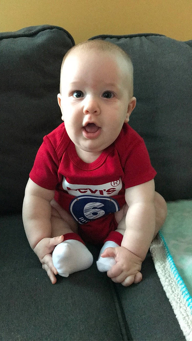 Zadryan is registered to the contest to win money with this photo: baby, baby_toddler_clothing, cheek, child, comfort, electric_blue, finger, floor, flooring, happy, head, human_body, knee, mouth, person, skin, sleeve, smile, sportswear, t_shirt