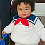 Draven is registered to the contest to win money with this photo: child, toddler, sailor_outfit, costume, red_bow, blue_shovel, indoor, wooden_floor, curly_hair, person, cute, plush, white_clothing, navy_collar, standing, toy, floor, adult, home, portrait