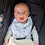 Ralph is registered to the contest to win money with this photo: baby, child, smiling, blue_eyes, bib, blanket, stroller, infant, happy, cute, clothing, seatbelt, person, face, hands, indoors, soft_toys, cozy, expression, portrait