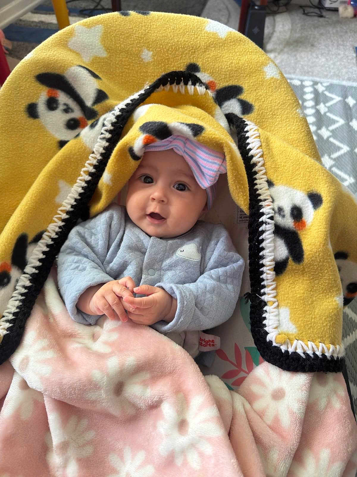 Felicia joined the competition — help win amazing prizes! baby, blanket, panda_print, pink_blanket, hat, clothing, infant, portrait, indoor, cozy, cute, smile, hands, face, child, warm, soft, person, headwear, seated
