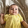 arm, baby, baby_garment, blanket, child, comfort, cute, eyes, face, happy, head, indoor, infant, lying_down, portrait, skin, smile, soft_texture, yellow_clothing, young