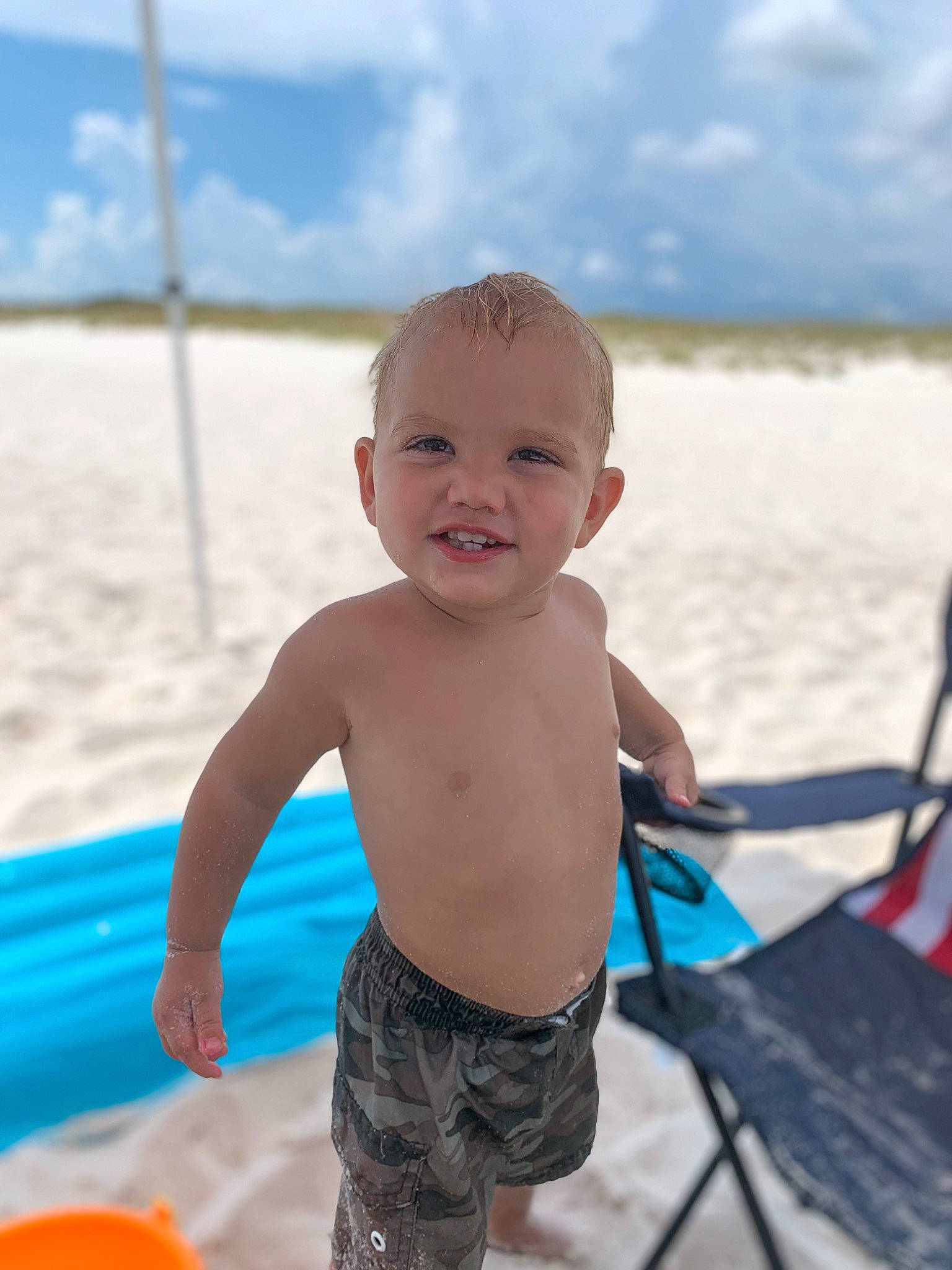 Chase is registered to the contest to win money with this photo: baby, beach, body_of_water, child, cloud, face, fun, happy, joy, leisure, people_in_nature, people_on_beach, person, recreation, sand, skin, sky, smile, standing, summer