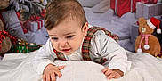 Isaac participe au concours pour gagner de l'argent avec cette photo : baby, child, plaid, white_blanket, christmas_tree, presents, teddy_bear, santa_hat, holiday, festive, cute, portrait, indoor, smiling, young_child, decorations, soft_texture, cozy, celebration, happy